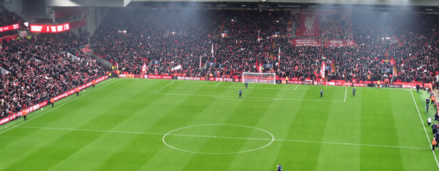 Wide-angle photograph of Anfield showing the pitch and packed stands, with the headline ‘Araújo’s defensive impact’ in white text across the top.