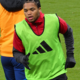 Rio Ngumoha wearing a green training bib during a Liverpool warm-up at Craven Cottage in January 2026.